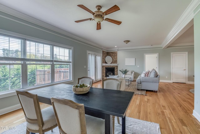 798 Hamilton Rd, Blountville, TN 37617 - dining space featuring ceiling fan, healthy amount of natural light, crown molding, a brick fireplace, and baseboards