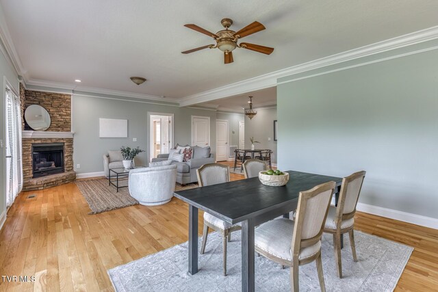798 Hamilton Rd, Blountville, TN 37617 - dining room featuring ceiling fan, ornamental molding, light wood finished floors, baseboards, and a stone fireplace