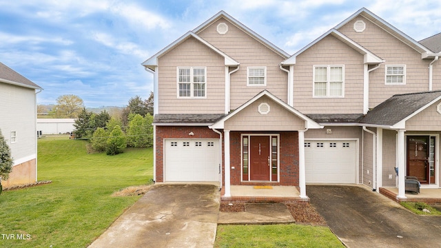 view of front of house featuring a garage, a front yard, brick siding, and driveway