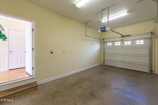 garage featuring baseboards and a garage door opener