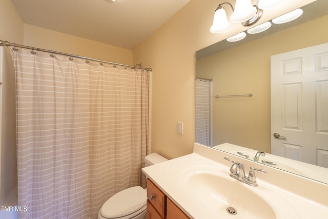 full bath featuring vanity and toilet