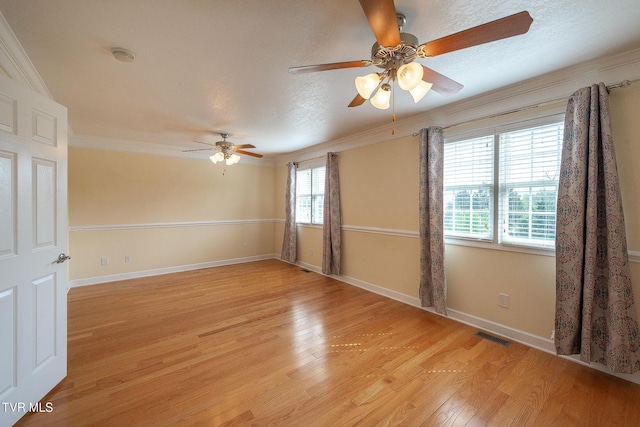 spare room with a wealth of natural light, light wood-type flooring, crown molding, and ceiling fan