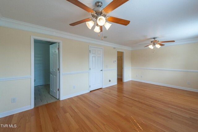 unfurnished room with baseboards, light wood-type flooring, ornamental molding, and ceiling fan