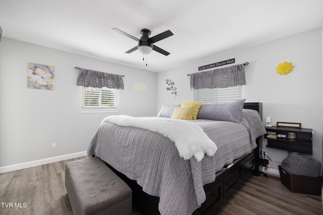 bedroom featuring ceiling fan, baseboards, and dark wood-style floors