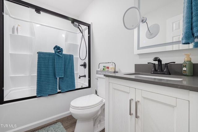 full bath featuring toilet, wood finished floors, vanity, and bath / shower combo with glass door