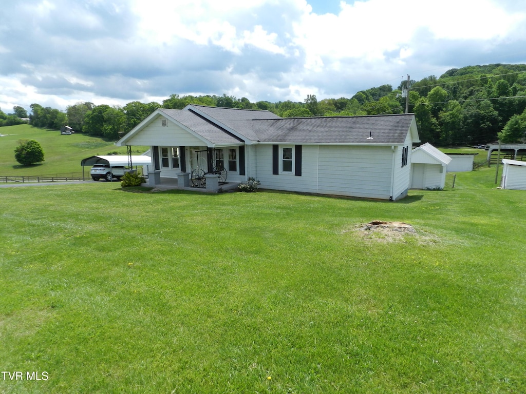 14930 Kingsport Hwy, Chuckey, TN 37641 - view of front of house with a shingled roof, fence, a front yard, and a carport