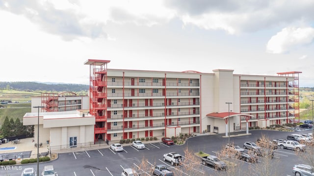 view of apartment building / complex featuring uncovered parking