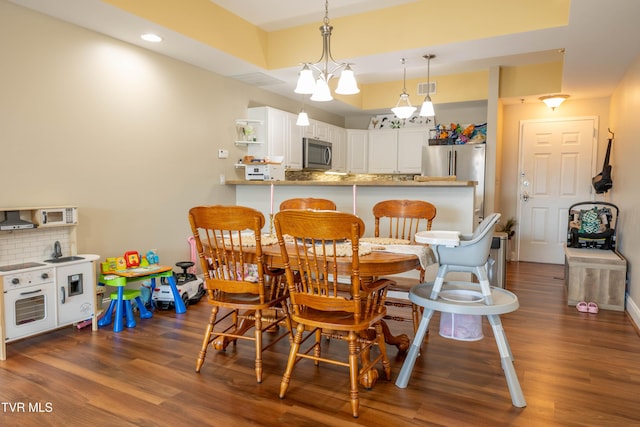 dining space featuring dark wood-style flooring and recessed lighting