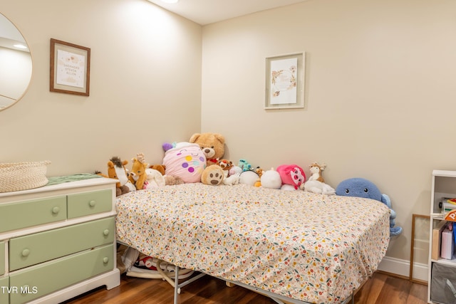 bedroom featuring wood finished floors and baseboards