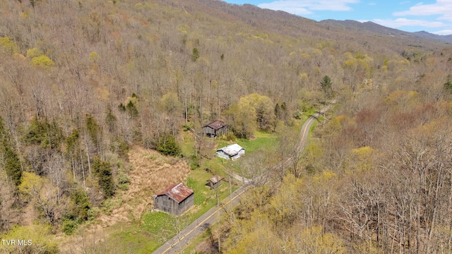 aerial view featuring a mountain view and a view of trees