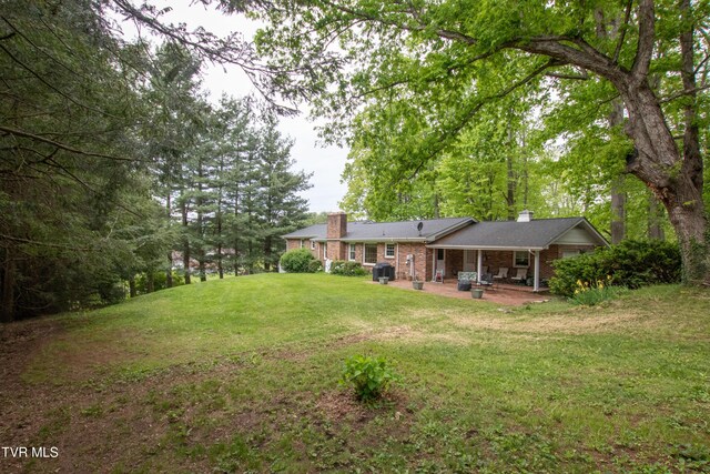 19494 Oakwood Dr, Abingdon, VA 24211 - view of green lawn with a patio area