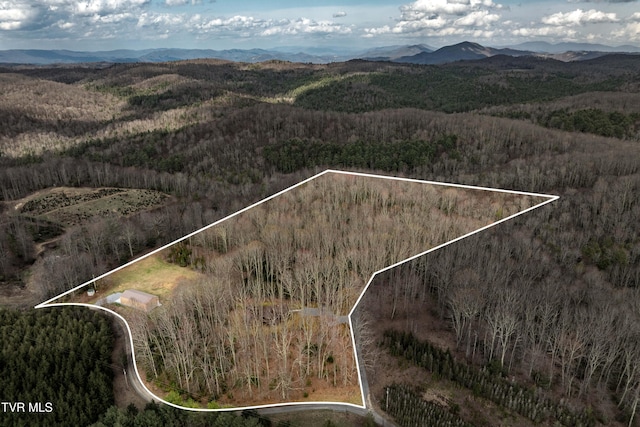 aerial view with a wooded view and a mountain view