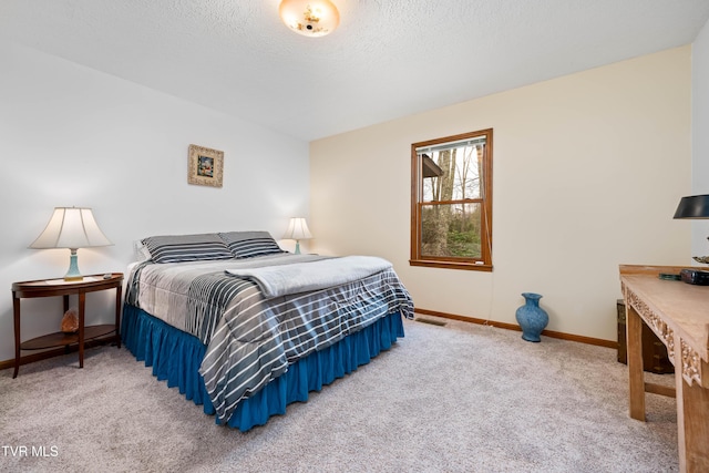 bedroom with baseboards, light carpet, and a textured ceiling