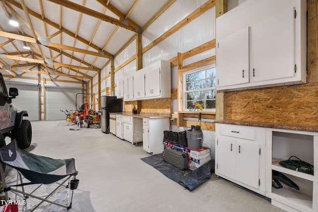 garage with freestanding refrigerator and metal wall