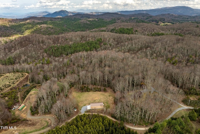 aerial view featuring a view of trees and a mountain view