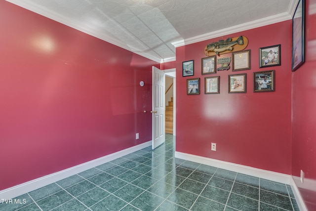 spare room featuring stairway, baseboards, crown molding, and dark tile patterned flooring
