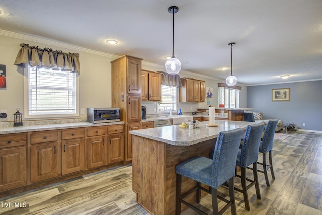 90 Darnell Rd, Greeneville, TN 37743 - kitchen with ornamental molding, brown cabinetry, light wood-type flooring, and a kitchen bar