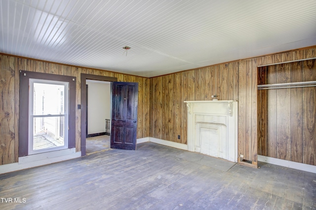 unfurnished bedroom featuring a closet, wood finished floors, and baseboards