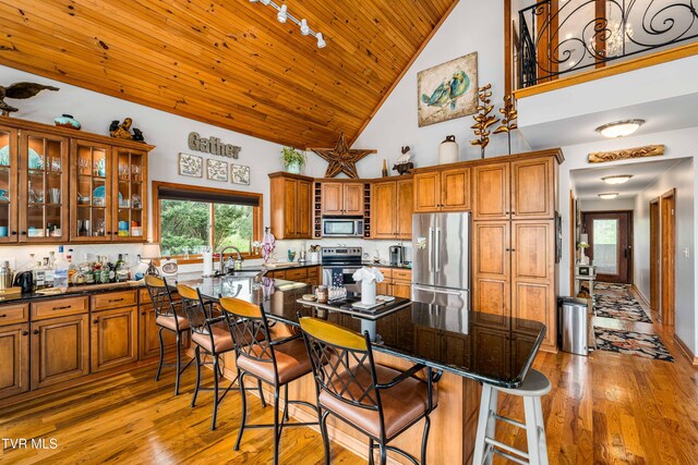 589 Harbor Point Rd, Butler, TN 37640 - kitchen featuring appliances with stainless steel finishes, brown cabinetry, high vaulted ceiling, a sink, and wood ceiling