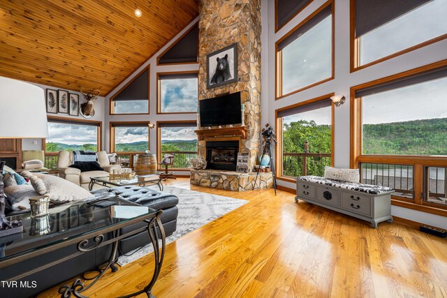 589 Harbor Point Rd, Butler, TN 37640 - living area with a stone fireplace, high vaulted ceiling, healthy amount of natural light, wood ceiling, and wood finished floors