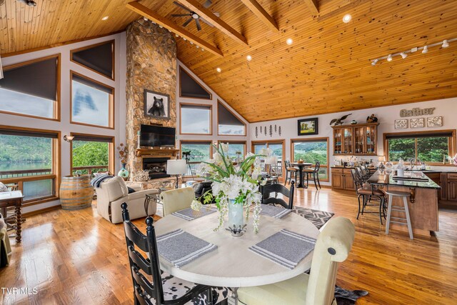 589 Harbor Point Rd, Butler, TN 37640 - dining space with wood ceiling, track lighting, light wood-type flooring, a fireplace, and high vaulted ceiling
