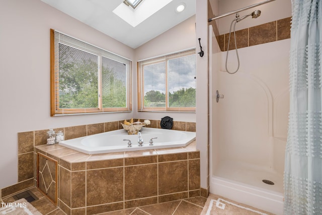 589 Harbor Point Rd, Butler, TN 37640 - bathroom with a skylight, a stall shower, a bath, vaulted ceiling, and tile patterned flooring