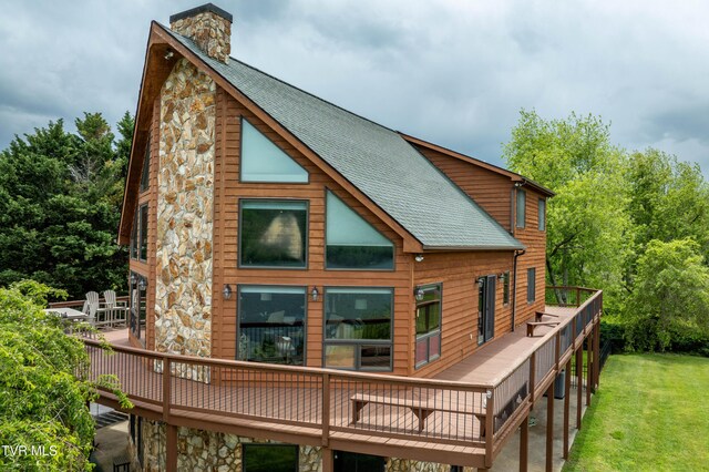589 Harbor Point Rd, Butler, TN 37640 - rear view of property with a deck, roof with shingles, a chimney, a lawn, and stone siding