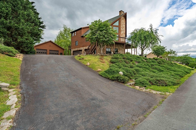 589 Harbor Point Rd, Butler, TN 37640 - view of front of property with stairway, stone siding, a garage, and a chimney