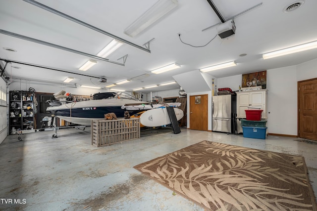 589 Harbor Point Rd, Butler, TN 37640 - garage featuring freestanding refrigerator and a garage door opener