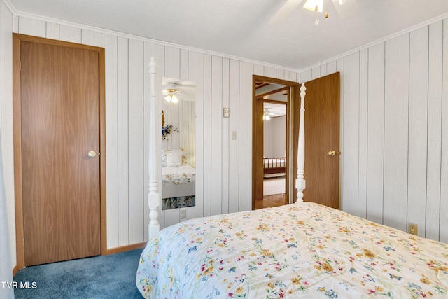 bedroom with crown molding, ceiling fan, and carpet floors