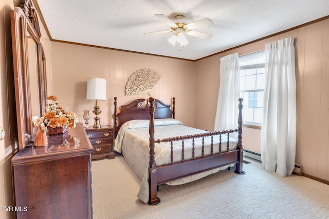 bedroom featuring a ceiling fan, a textured ceiling, light colored carpet, and ornamental molding