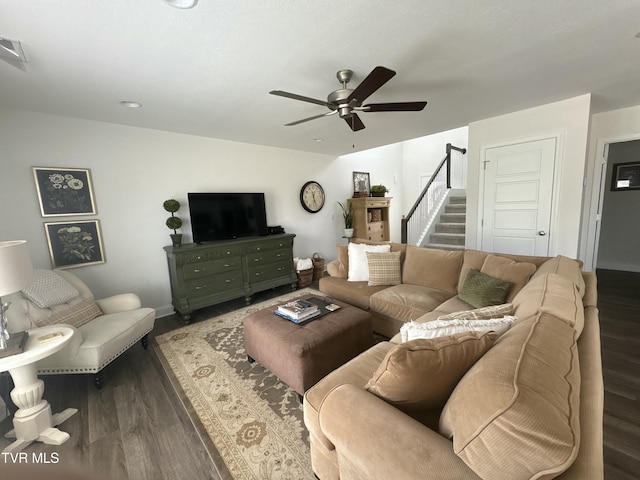 living area with stairway, wood finished floors, visible vents, and ceiling fan