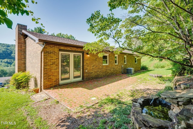 132 Lancaster Dr, Kingsport, TN 37663 - back of house featuring a chimney, brick siding, and a patio area