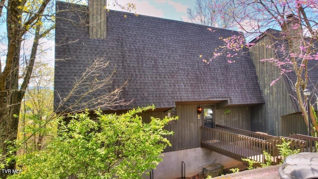 view of property exterior featuring roof with shingles