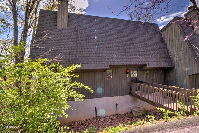 exterior space with a shingled roof