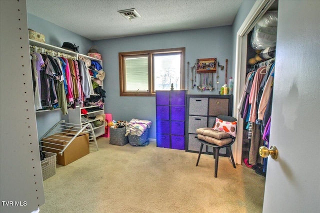 walk in closet with visible vents and carpet floors
