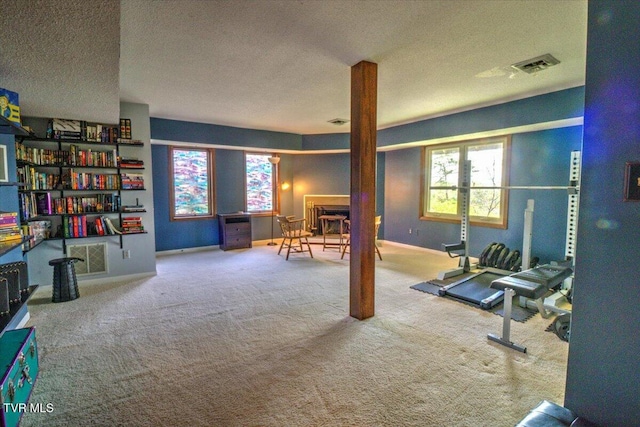 interior space with carpet flooring, visible vents, and a textured ceiling