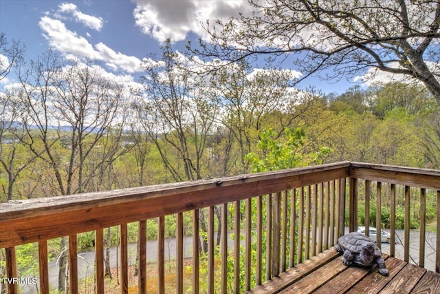 wooden deck featuring a wooded view