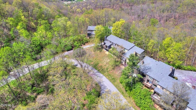 birds eye view of property with a view of trees