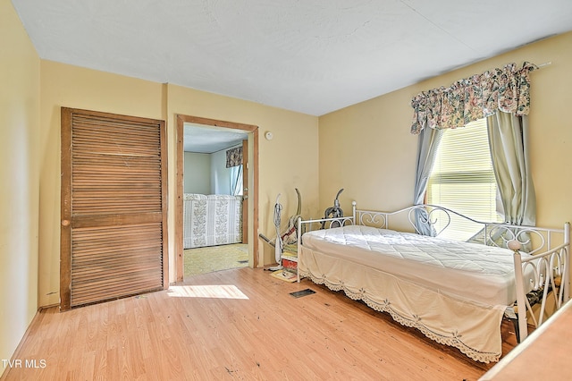 bedroom with light wood finished floors