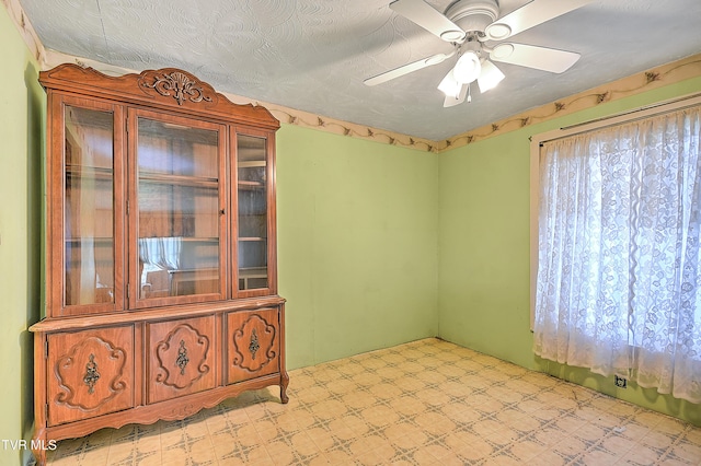 empty room featuring ceiling fan and light floors