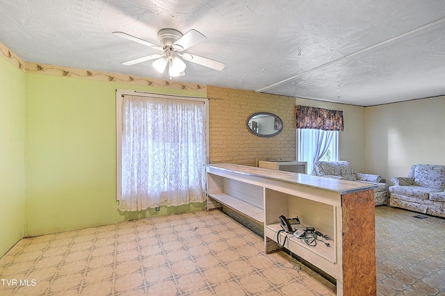 kitchen with open floor plan, a textured ceiling, and ceiling fan