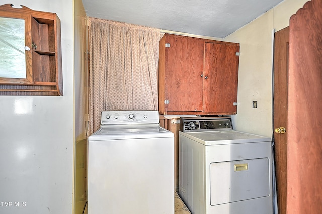 washroom featuring independent washer and dryer and cabinet space