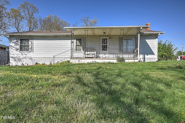 ranch-style house featuring a front yard and a porch