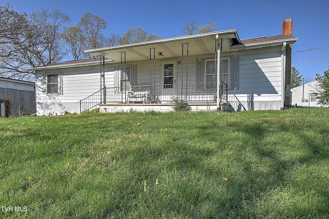 single story home with a porch and a front lawn