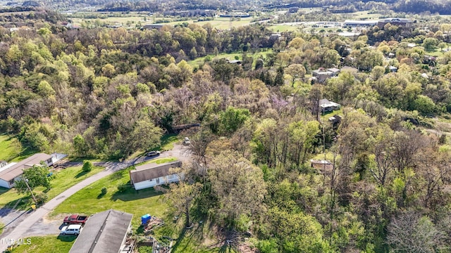 birds eye view of property with a wooded view