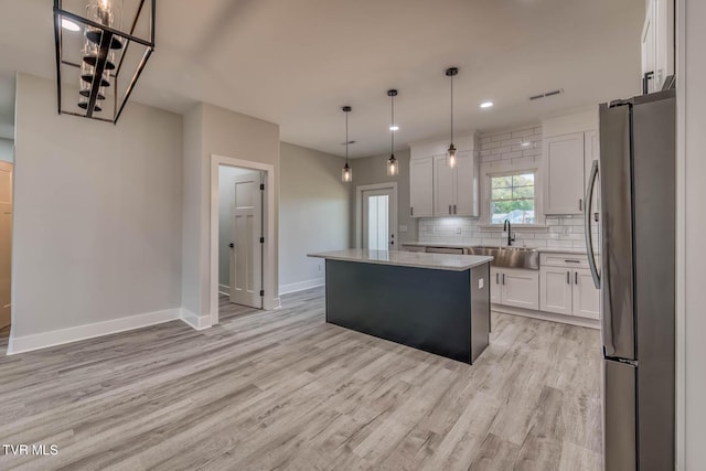 74 Slonaker Cir, Jonesborough, TN 37659 - kitchen featuring light wood-style flooring, freestanding refrigerator, a sink, baseboards, and visible vents