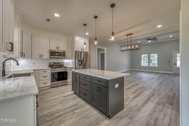 74 Slonaker Cir, Jonesborough, TN 37659 - kitchen featuring light wood finished floors, a sink, stainless steel appliances, a ceiling fan, and backsplash