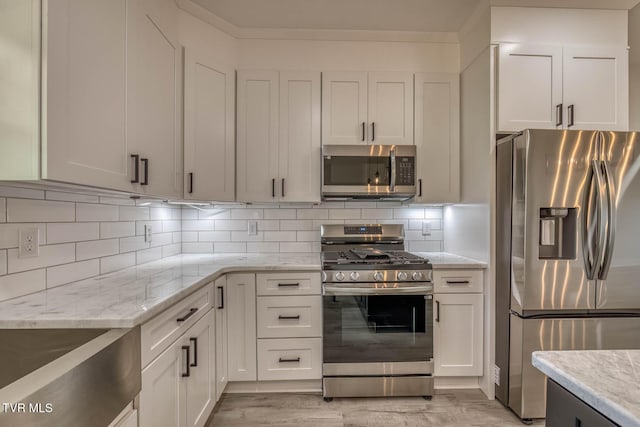 74 Slonaker Cir, Jonesborough, TN 37659 - kitchen featuring light stone countertops, white cabinets, stainless steel appliances, and tasteful backsplash