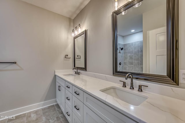 74 Slonaker Cir, Jonesborough, TN 37659 - bathroom with baseboards, tiled shower, double vanity, and a sink